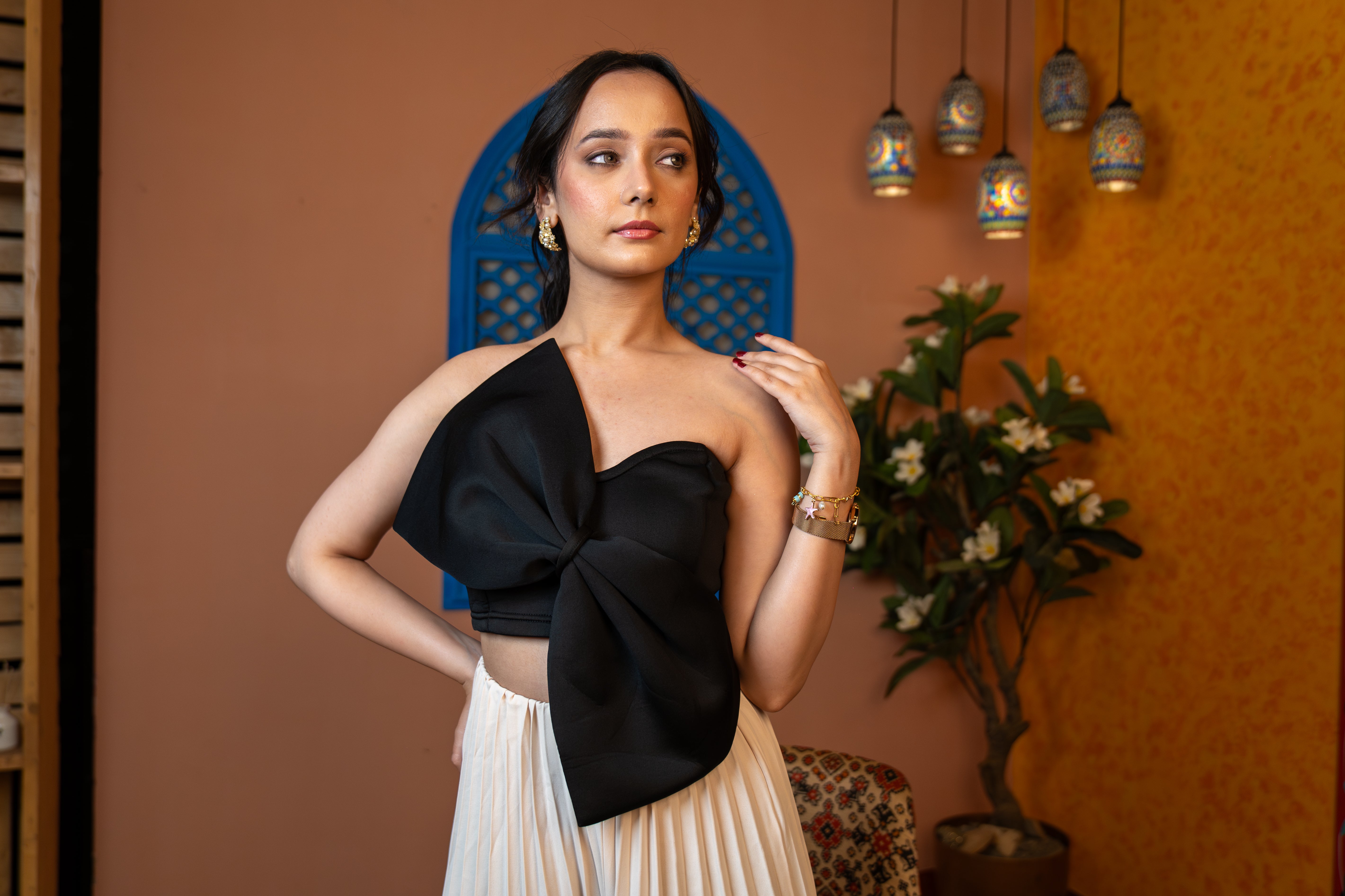 woman wearing Midnight black bow crop top with corset fit