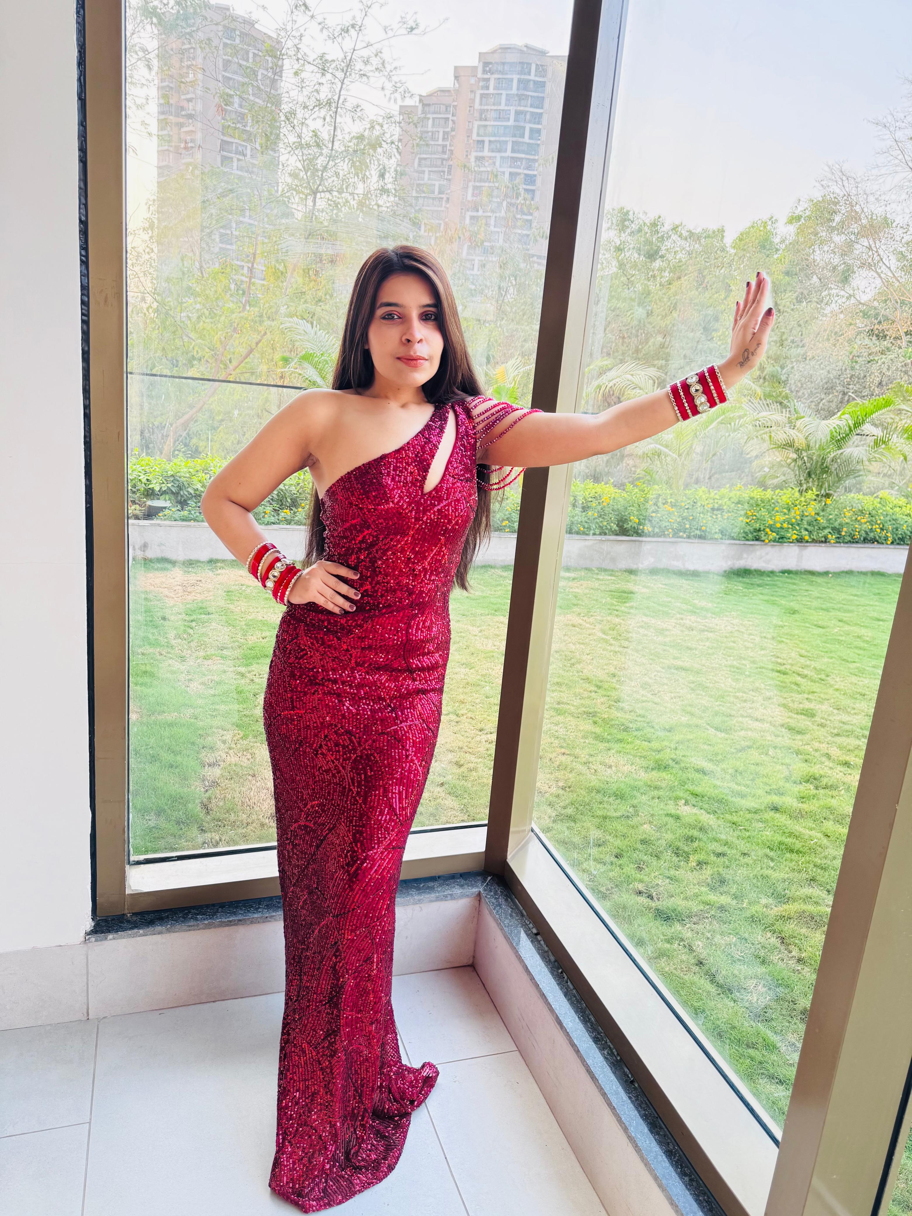 Woman wearing a One-Shoulder Red Sequin Dress.