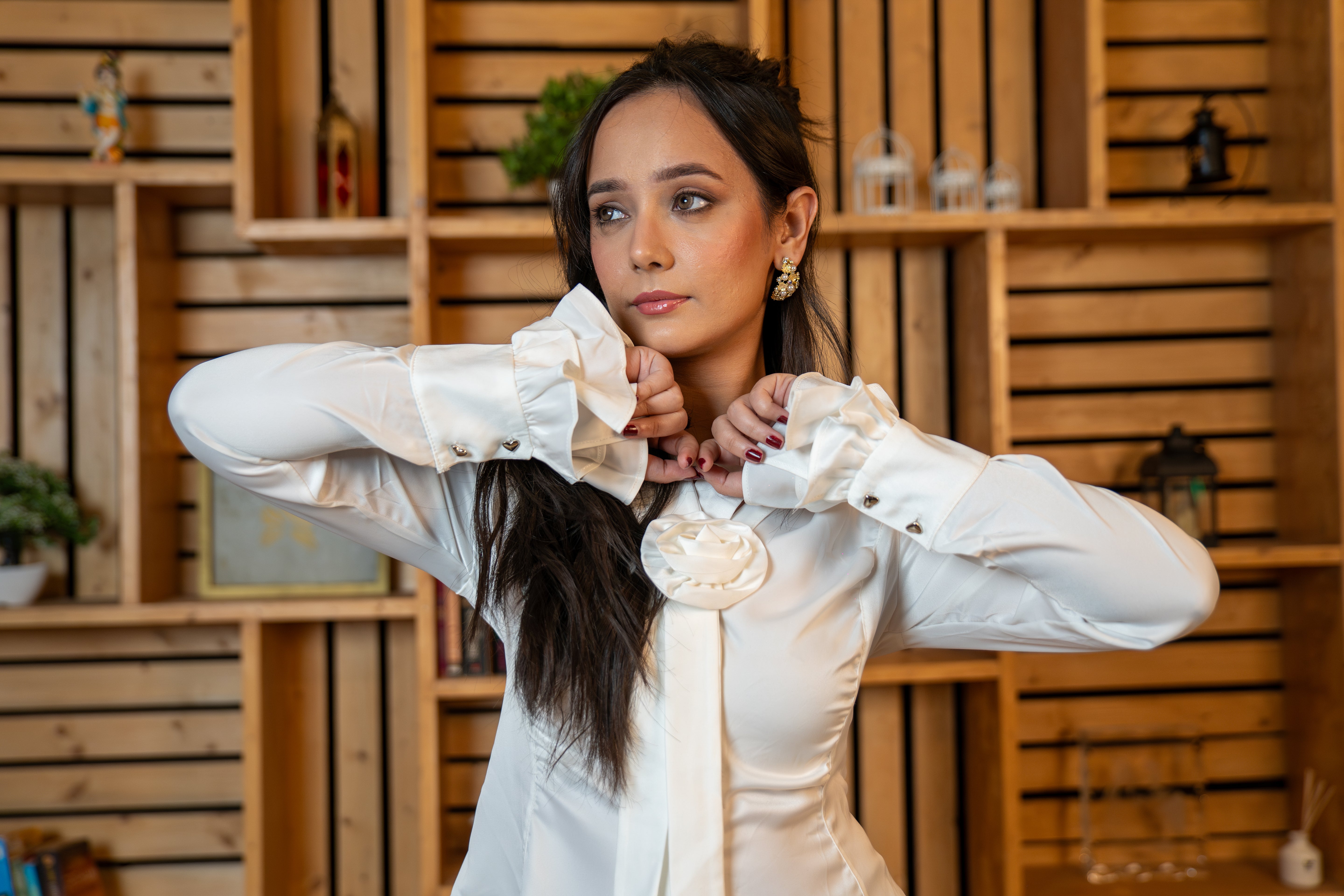 Woman wearing white rosette shirt with flounced sleeves front profile