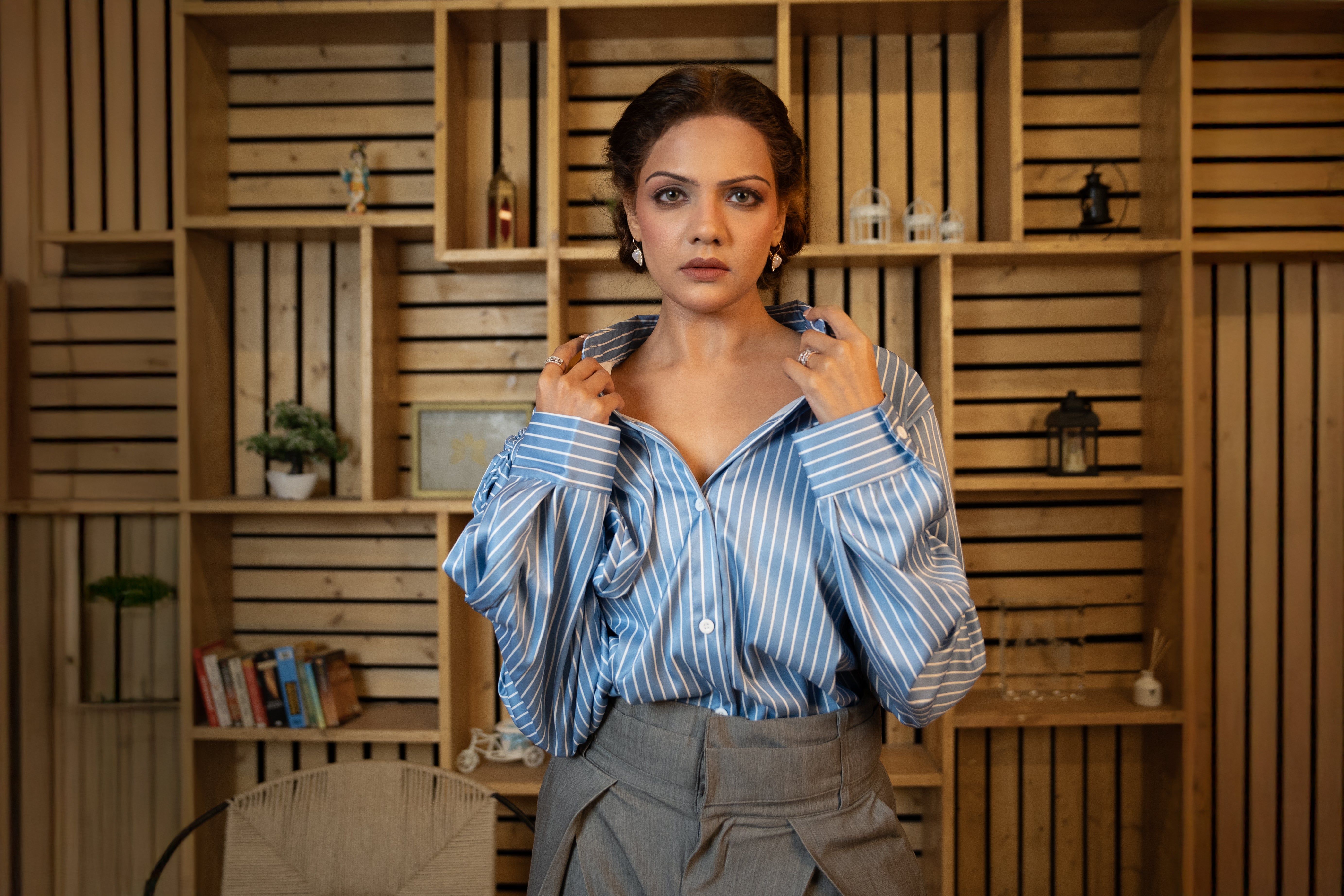 Woman wearing blue and white striped cotton shirt with oversized bow