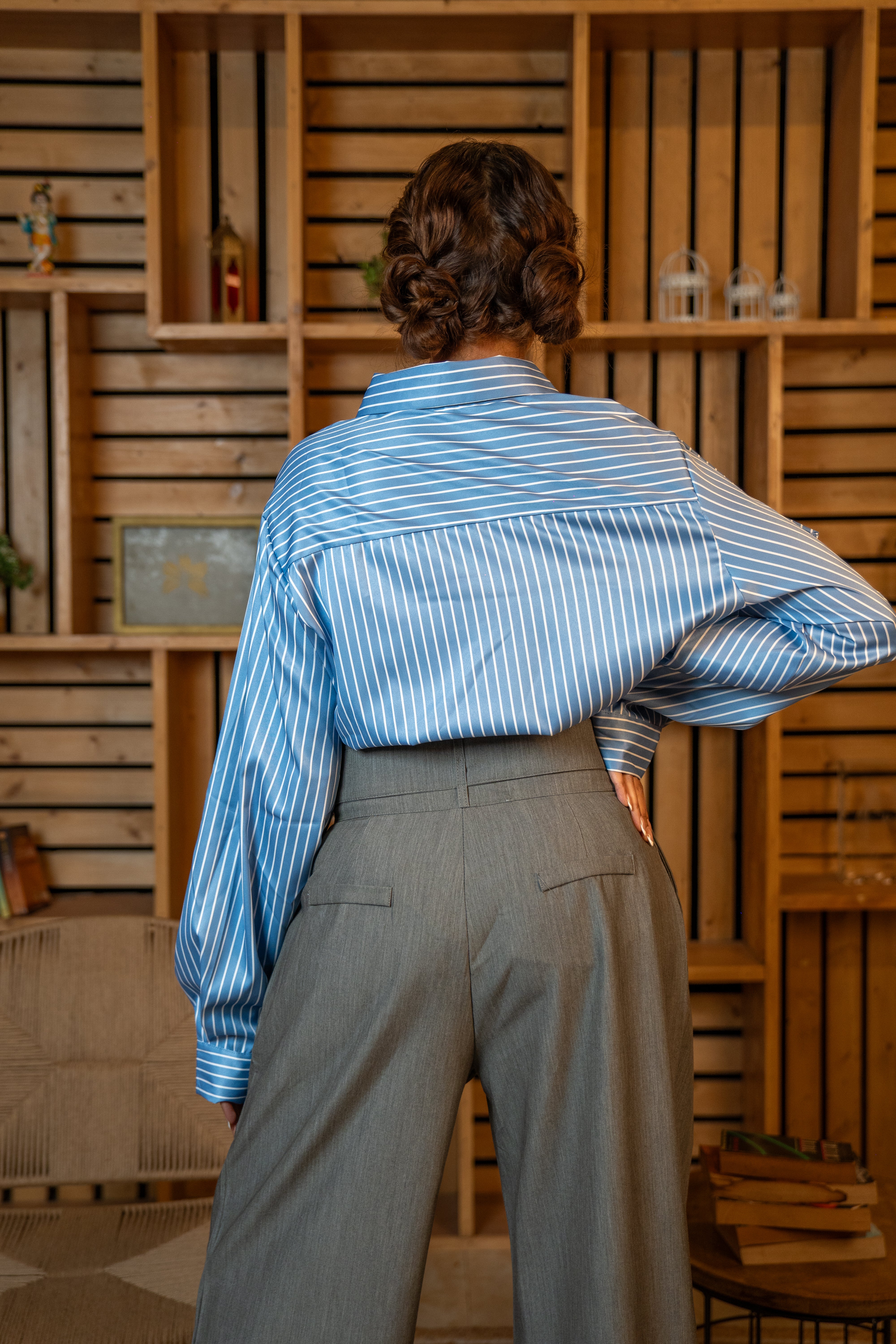 back view of Statement blue striped office shirt on model