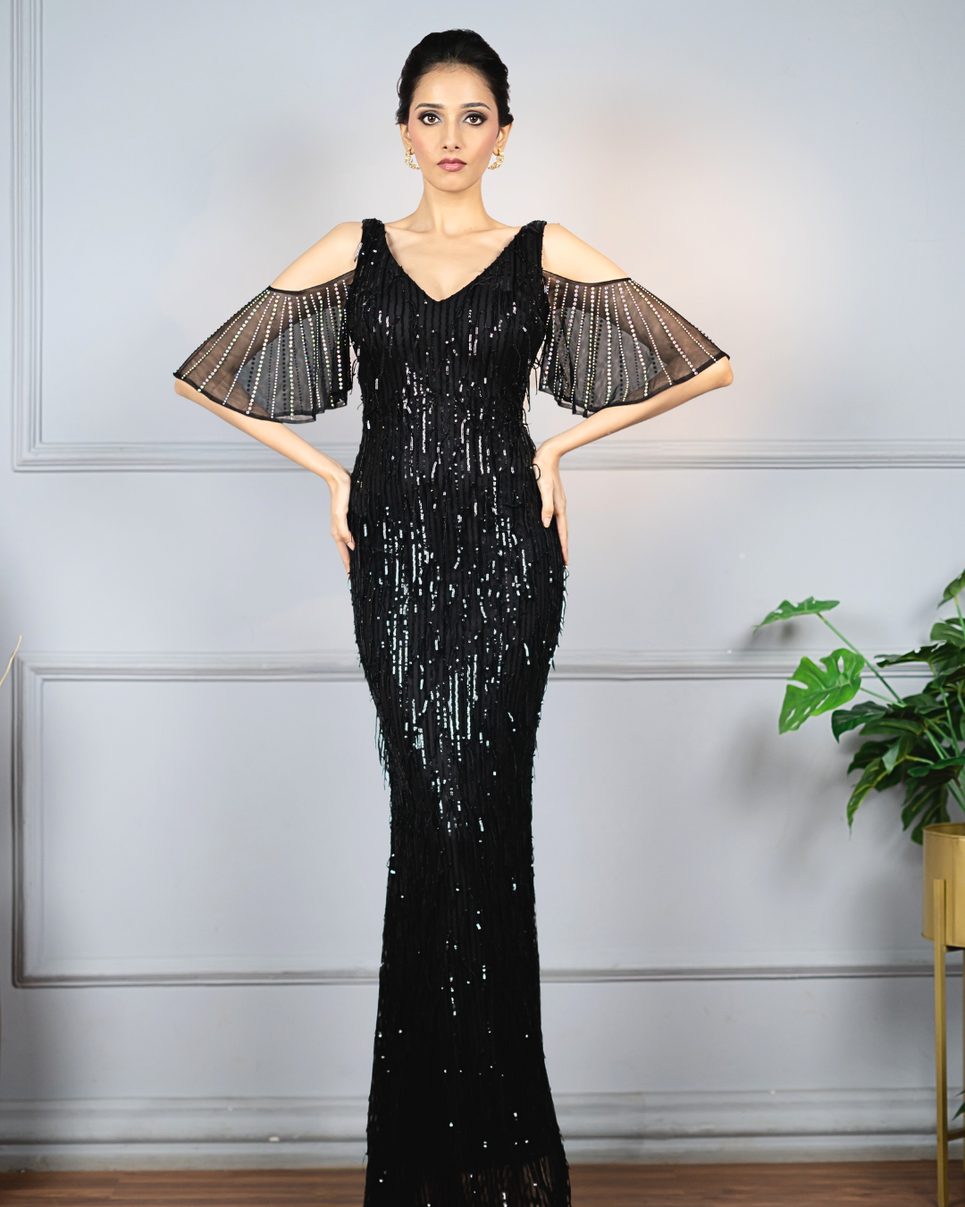 Woman wearing a black sequined tasselled gown 